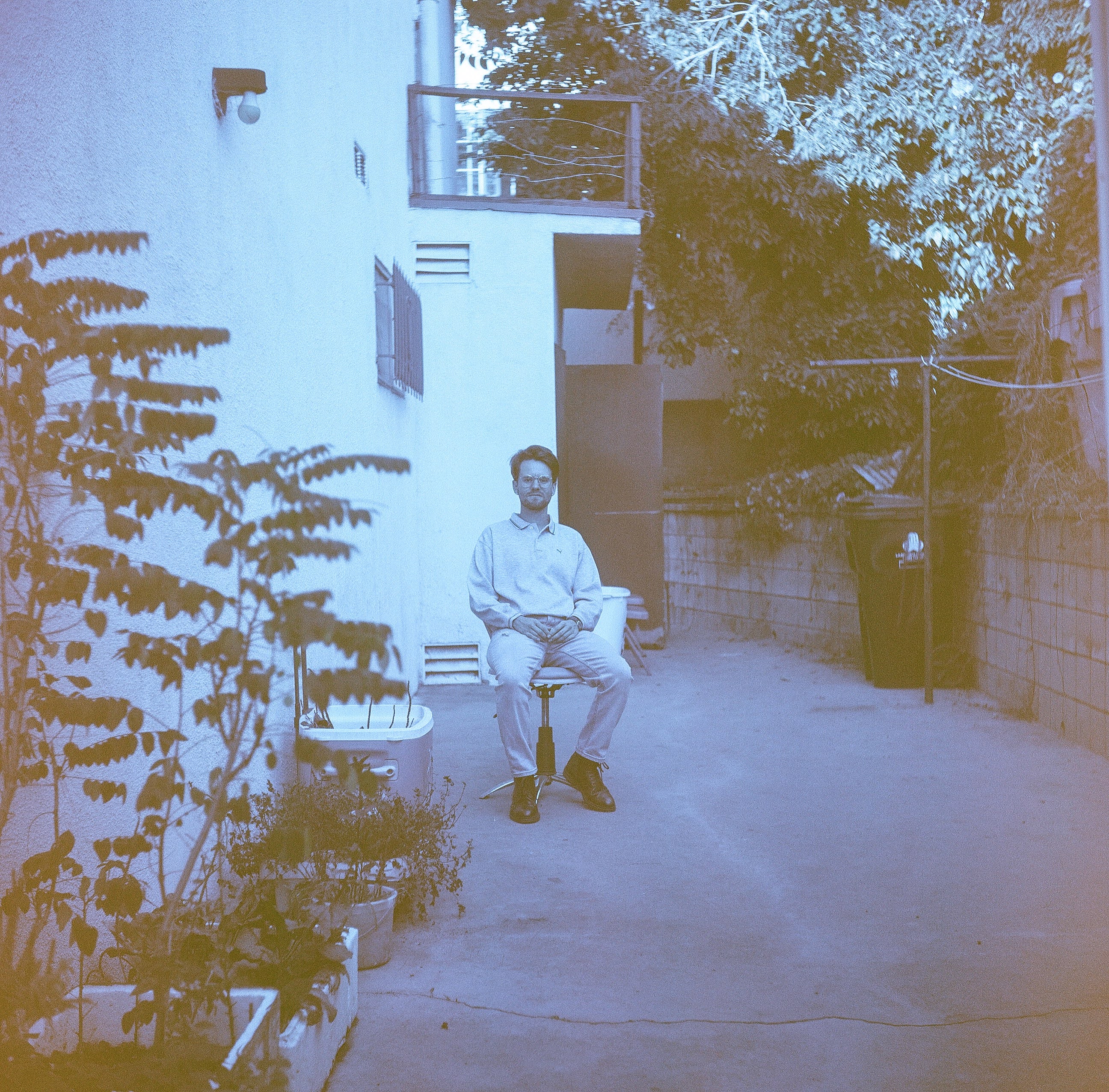 Atticus Reynolds sitting in a courtyard
